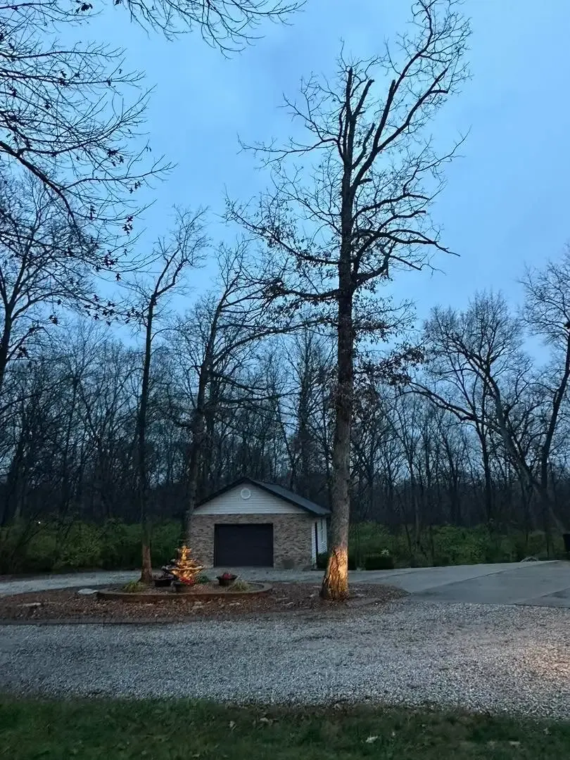Storm-damaged tree threatening a home in St. Charles, MO before emergency cleanup by BC's Tree Service